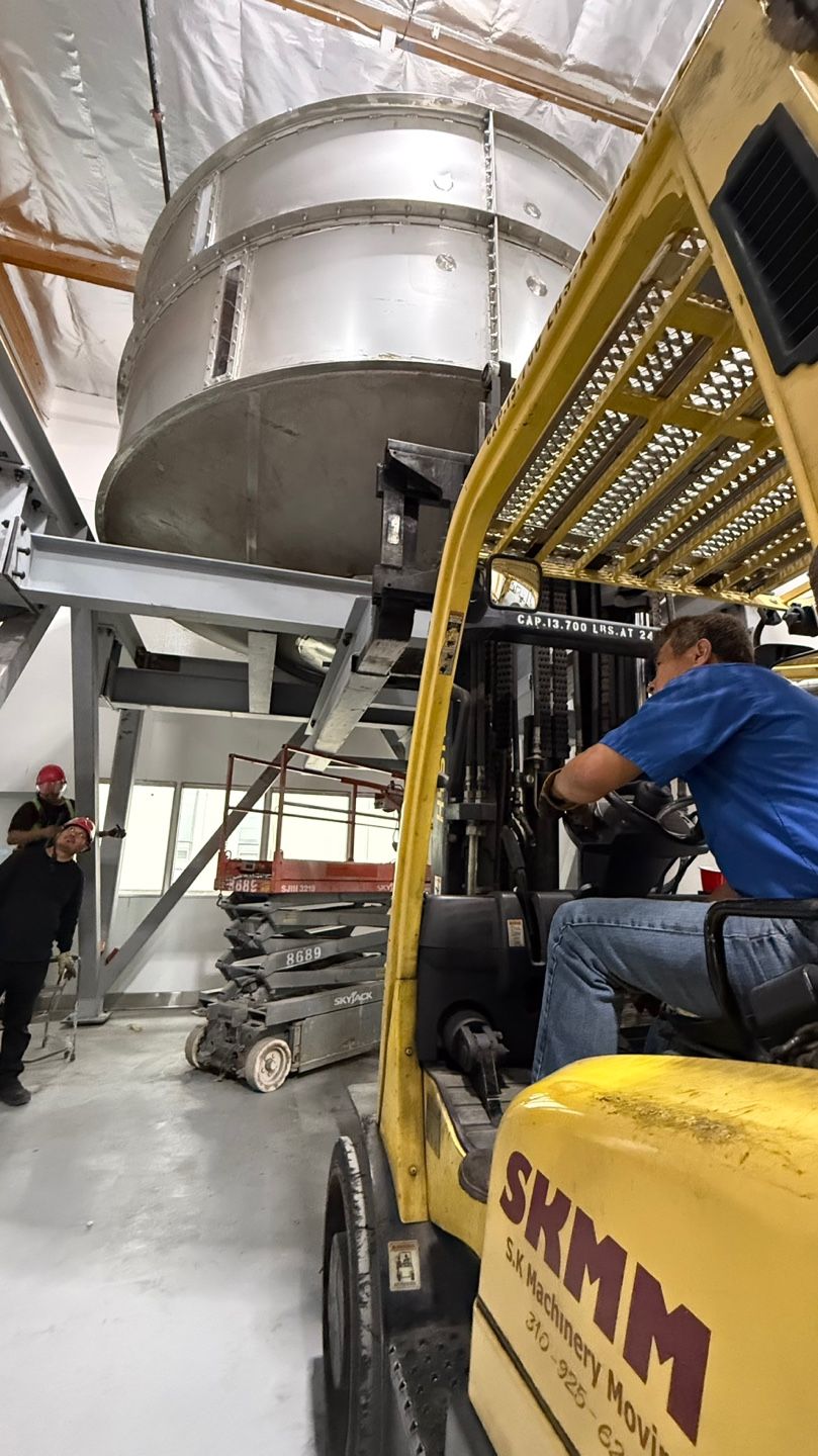 S.K. Machinery Moving crew rigging a large stainless steel tank into place